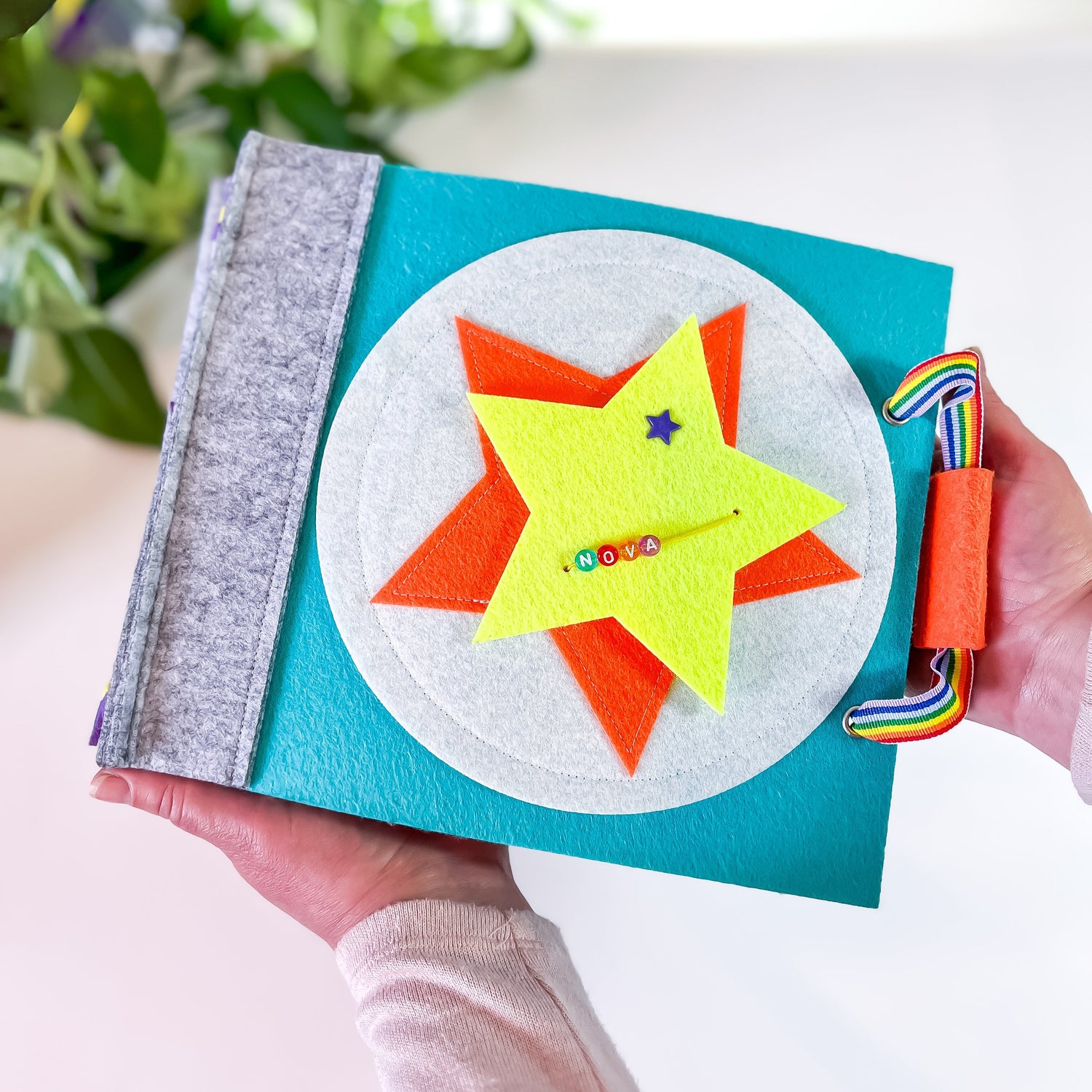 Personalized childrens book held by a moms hands