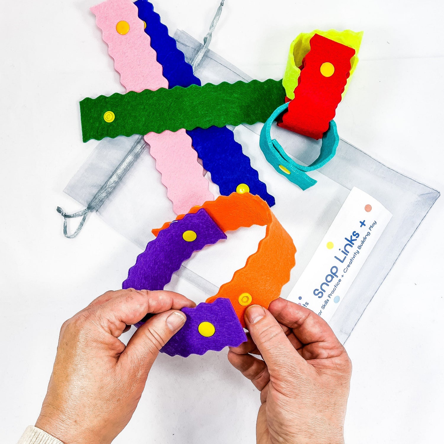 Re-useable paper chains made from felt with snaps to help kids develop strong fine motor skills