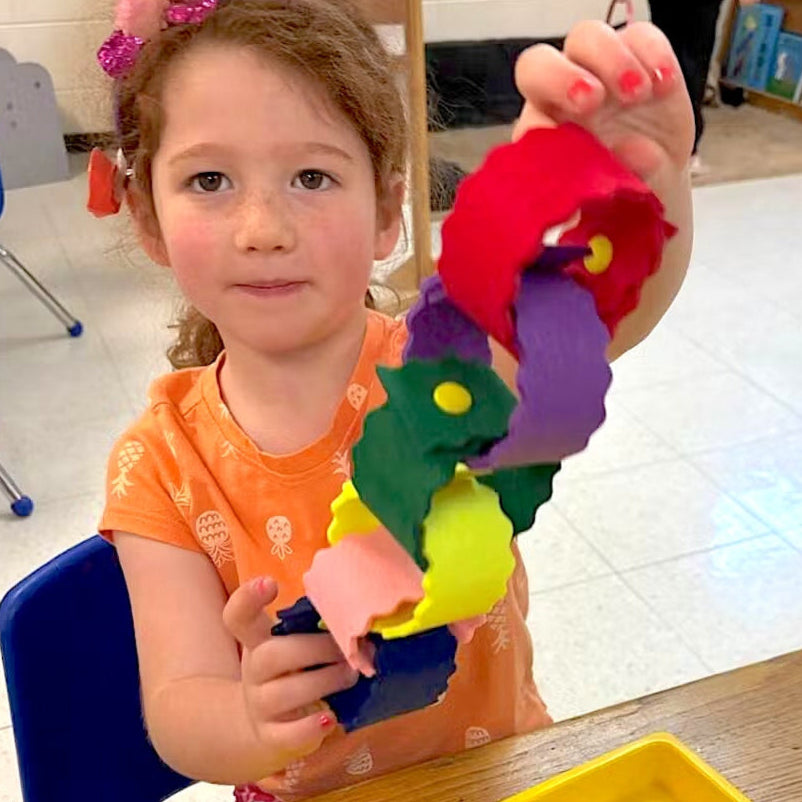 Child playing with colorful toy in a classroom setting