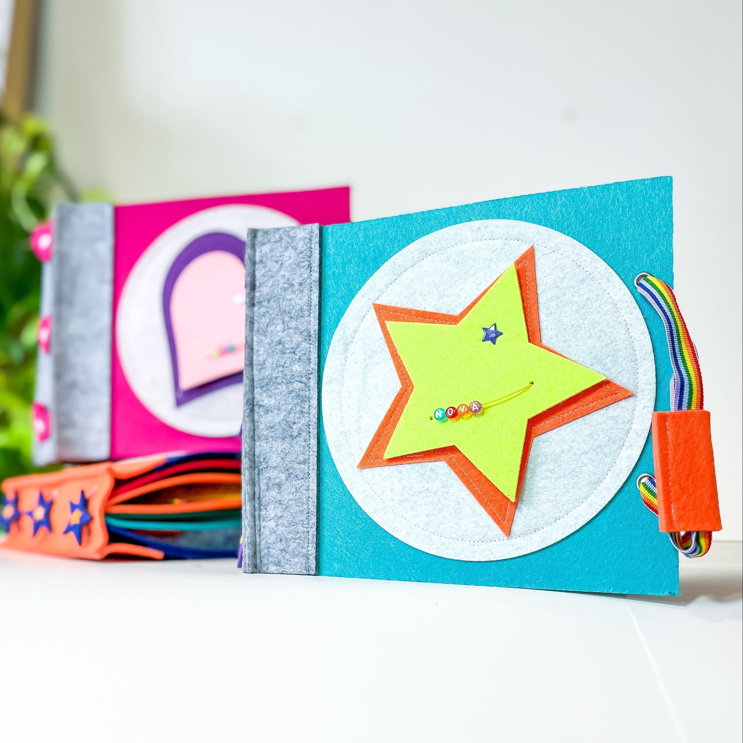 Colorful children's book with star and rainbow design on a white surface