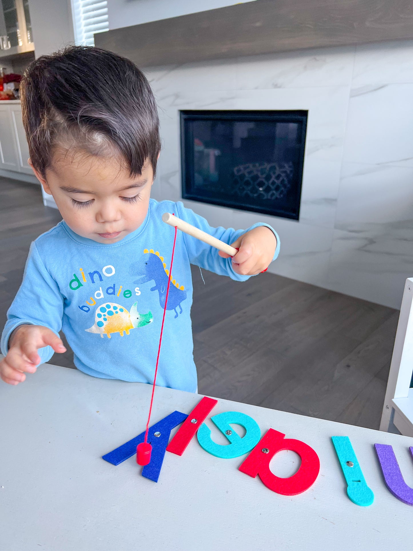 Toddler playing with magnetic fishing game
