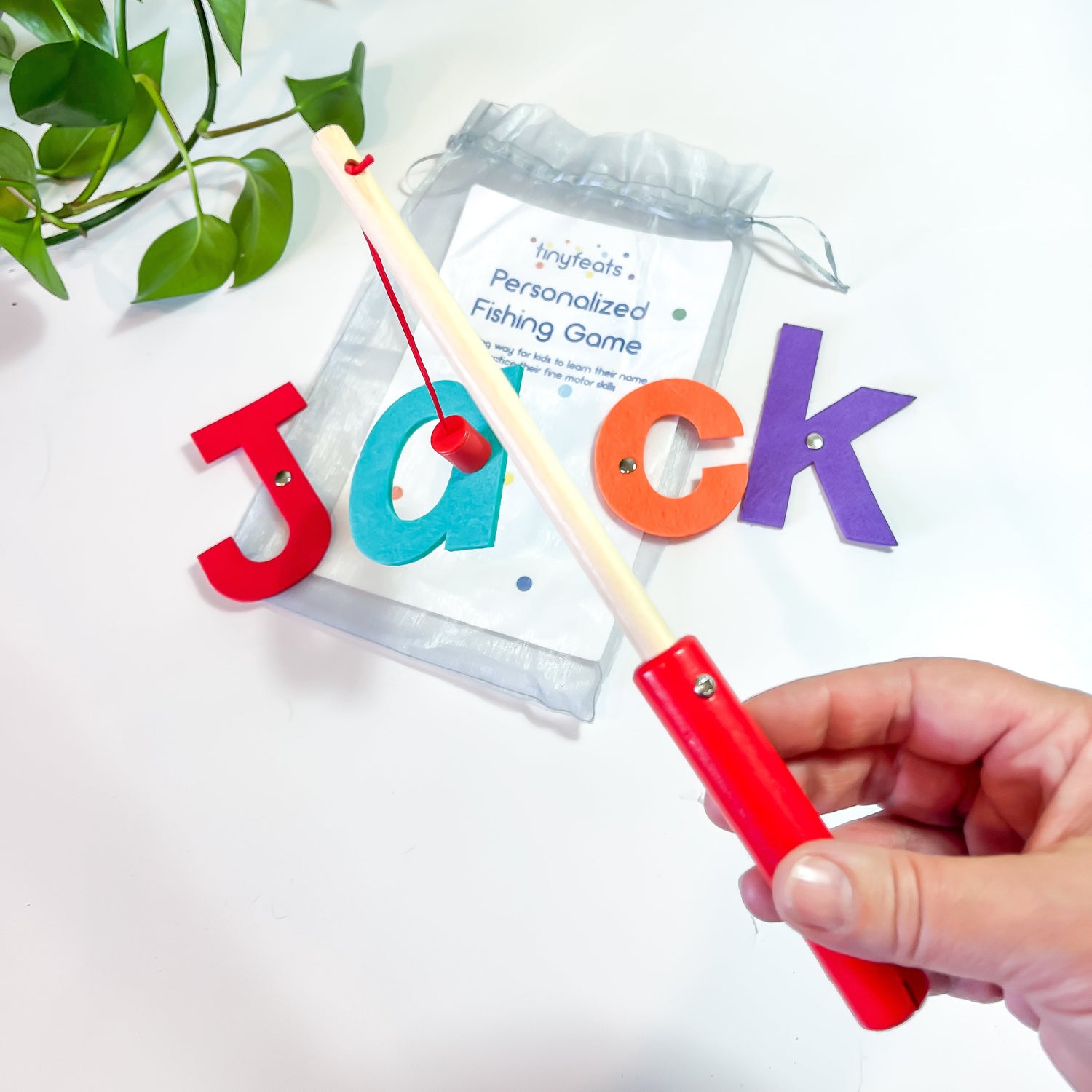 Personalized toy fishing game with name letters for kids on a white background
