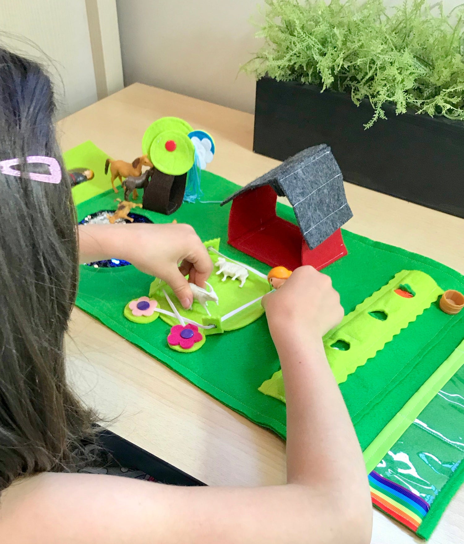 Child playing with a farm small world play set